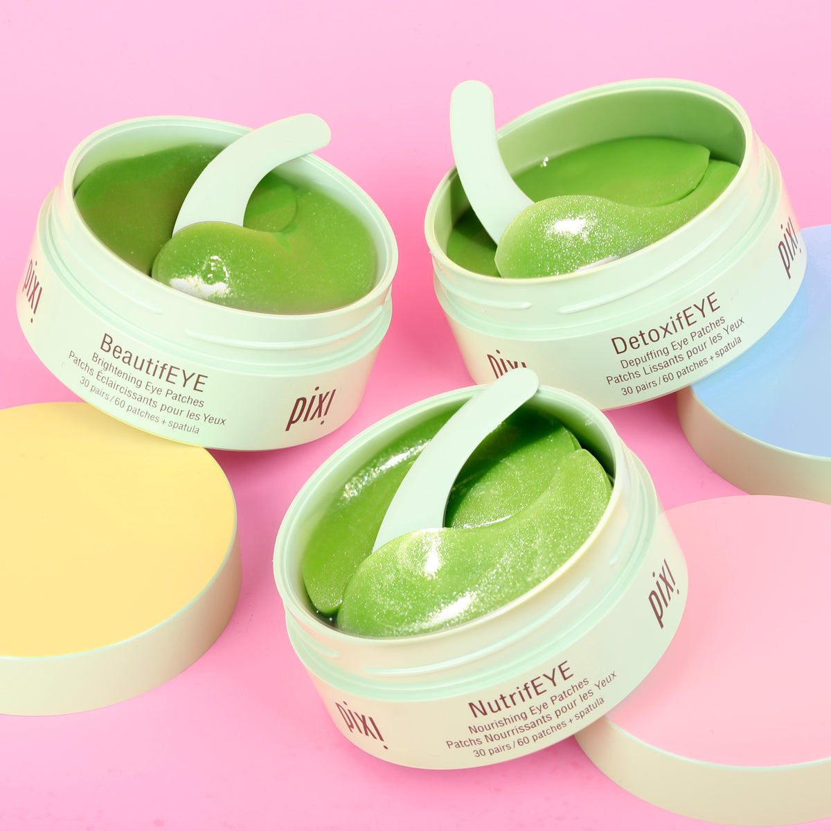 Three jars of Pixi eye patches on a pink background - BeautifEYE, DetoxifEYE and NutrifEYE shown.