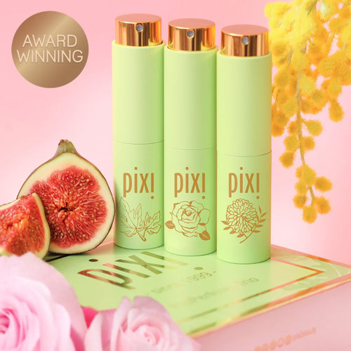 Award Winning: PixiPerfume Gift Trio shown on a pink background with plants view 1