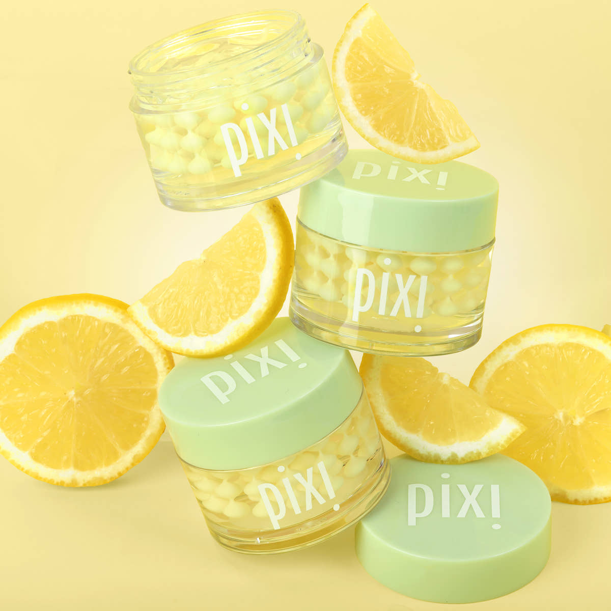 Vitamin-C CremeSerum with lemon slices on a yellow background