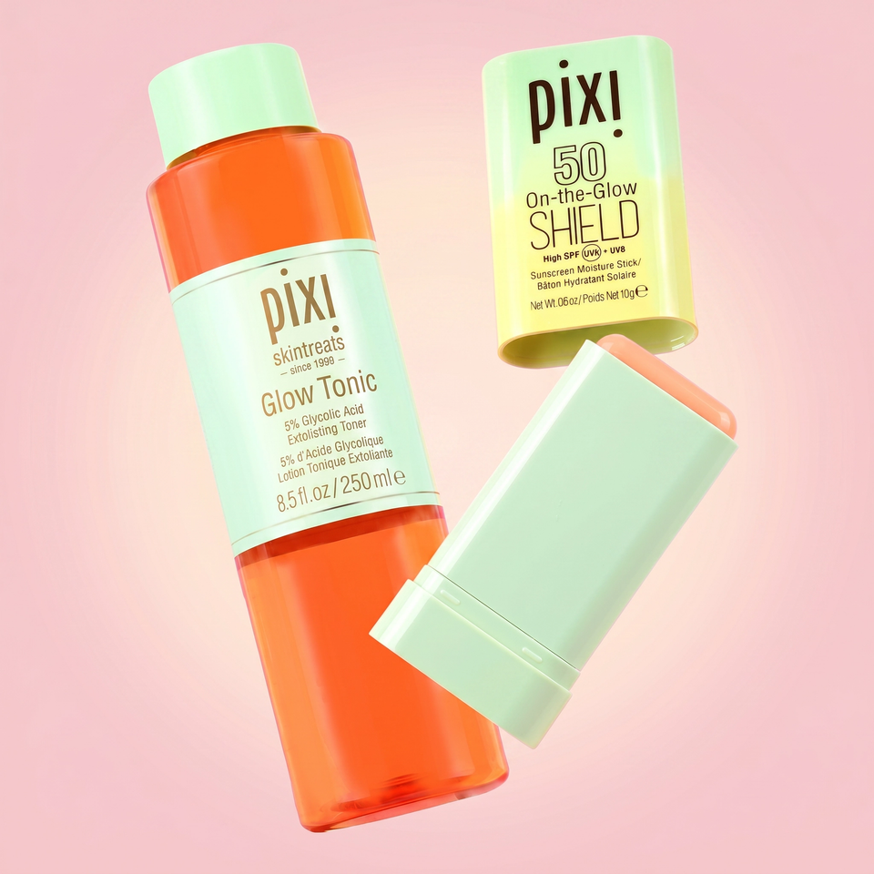 Pixi skincare products including Glow Tonic and SHIELD SPF 50 on a pink background view 1